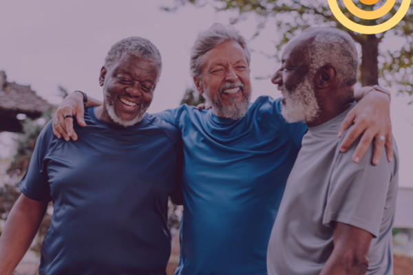 three men, smiling, walking together
